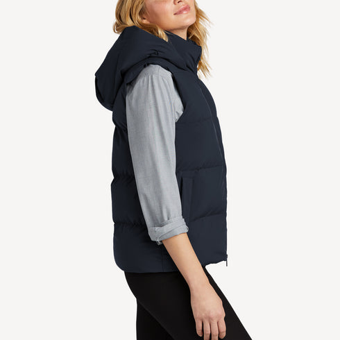 Side view of women’s navy waterproof puffer vest on model – Louvóre apparel